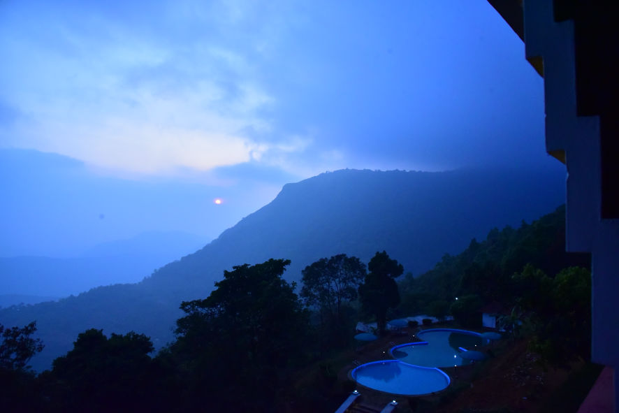 Aerial view of misty valley below Paithalmala